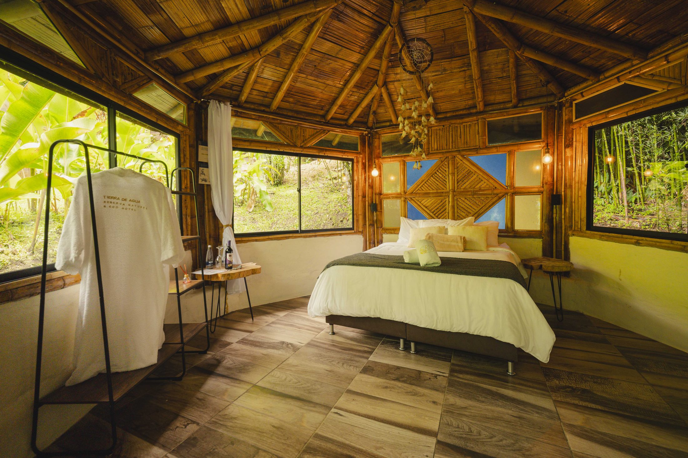 Quiet cabin interior with white robe and morning jungle light